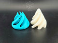 Turquoise outer shell and white inner core shown separated before assembly